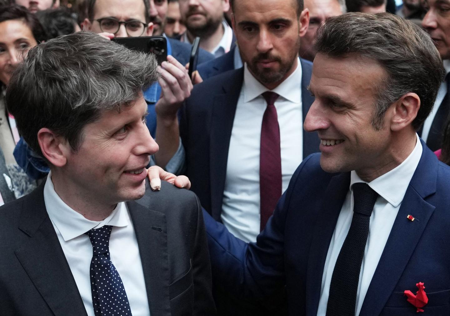 French President Emmanuel Macron speaks with Sam Altman, CEO of OpenAI.