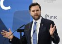 JD Vance speaks in front of a microphone to world leaders