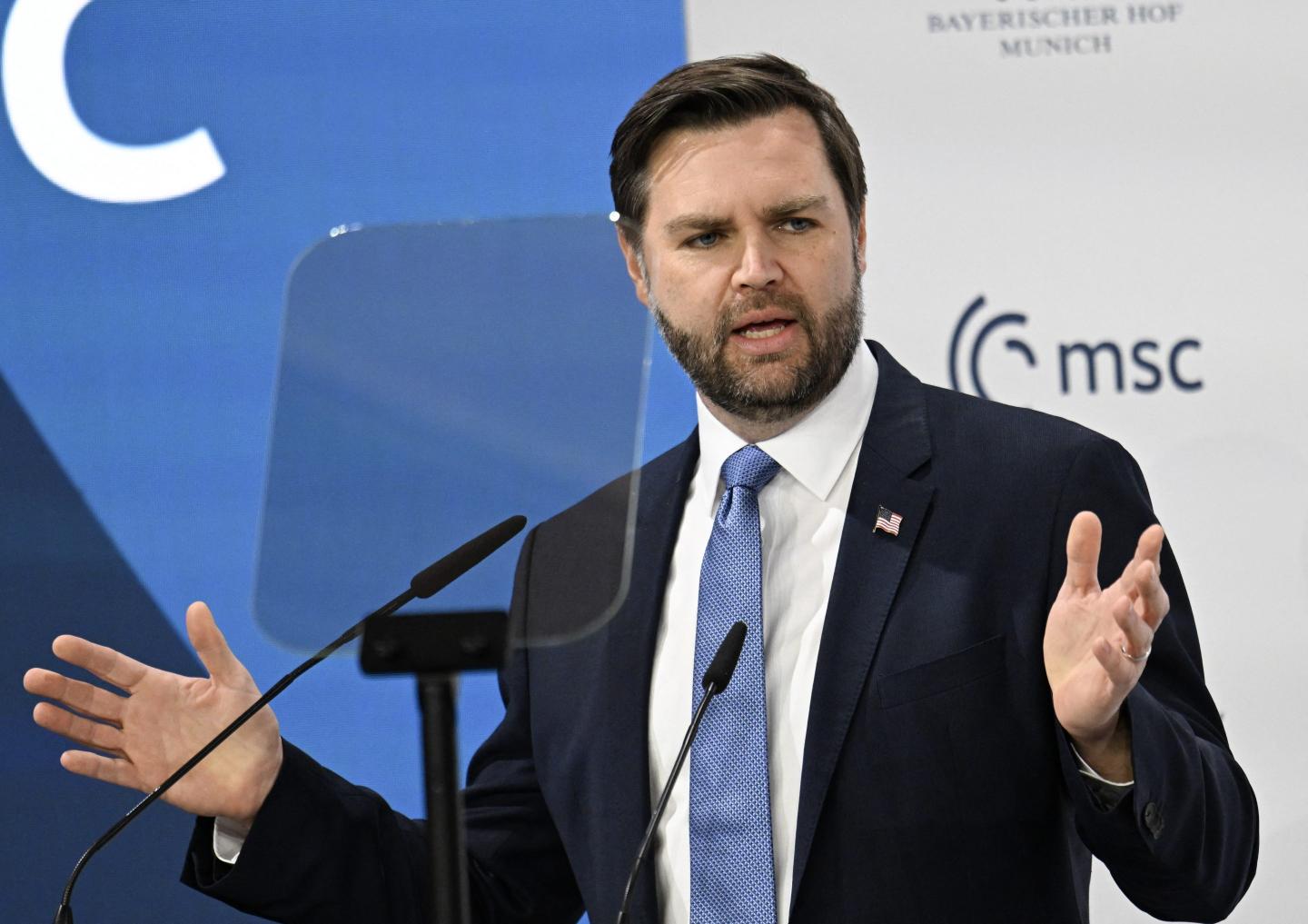 JD Vance speaks in front of a microphone to world leaders