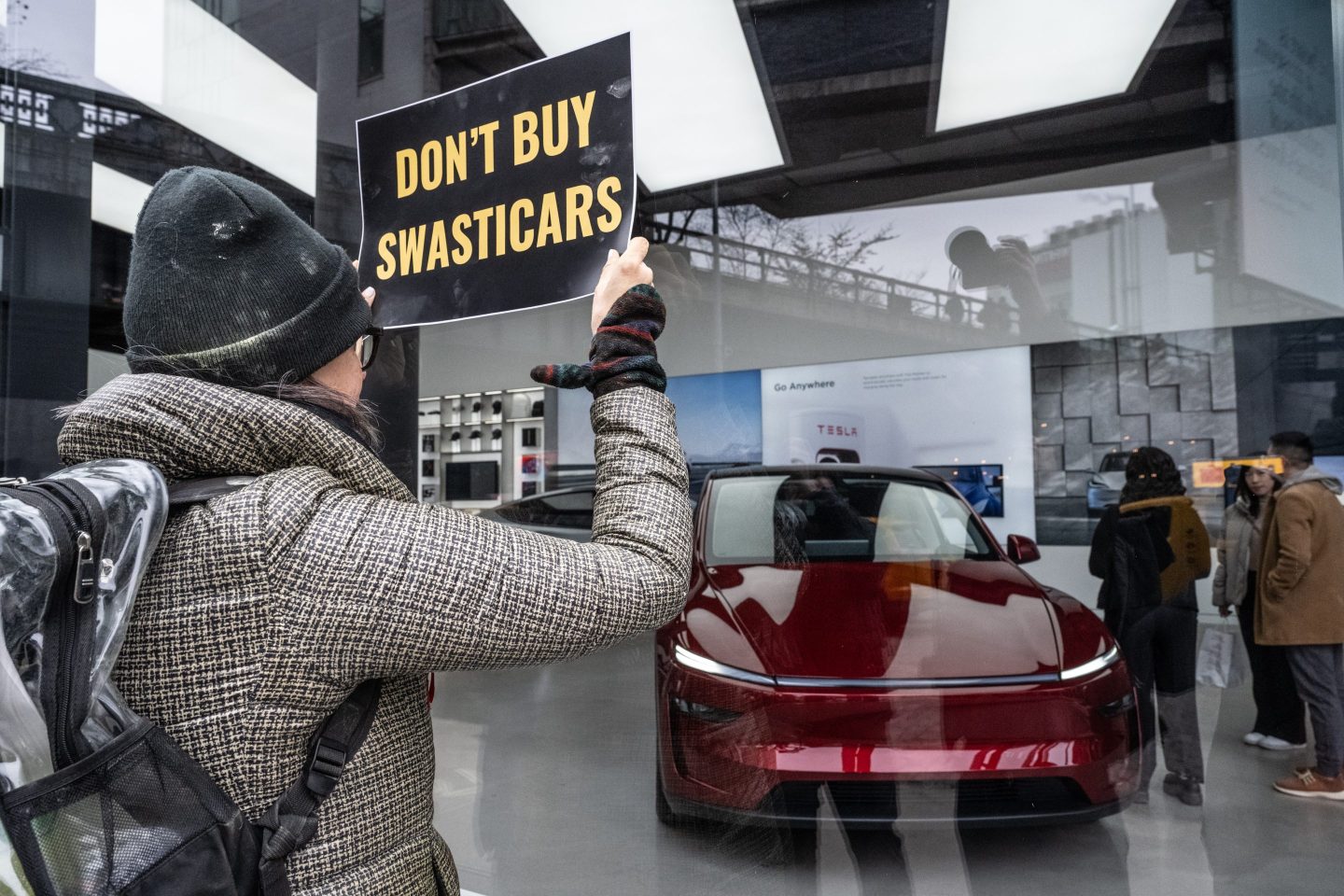 Protesters rally against Elon Musk's actions in the Trump administration at a Tesla showroom in New York, US, on Saturday, Feb. 15.