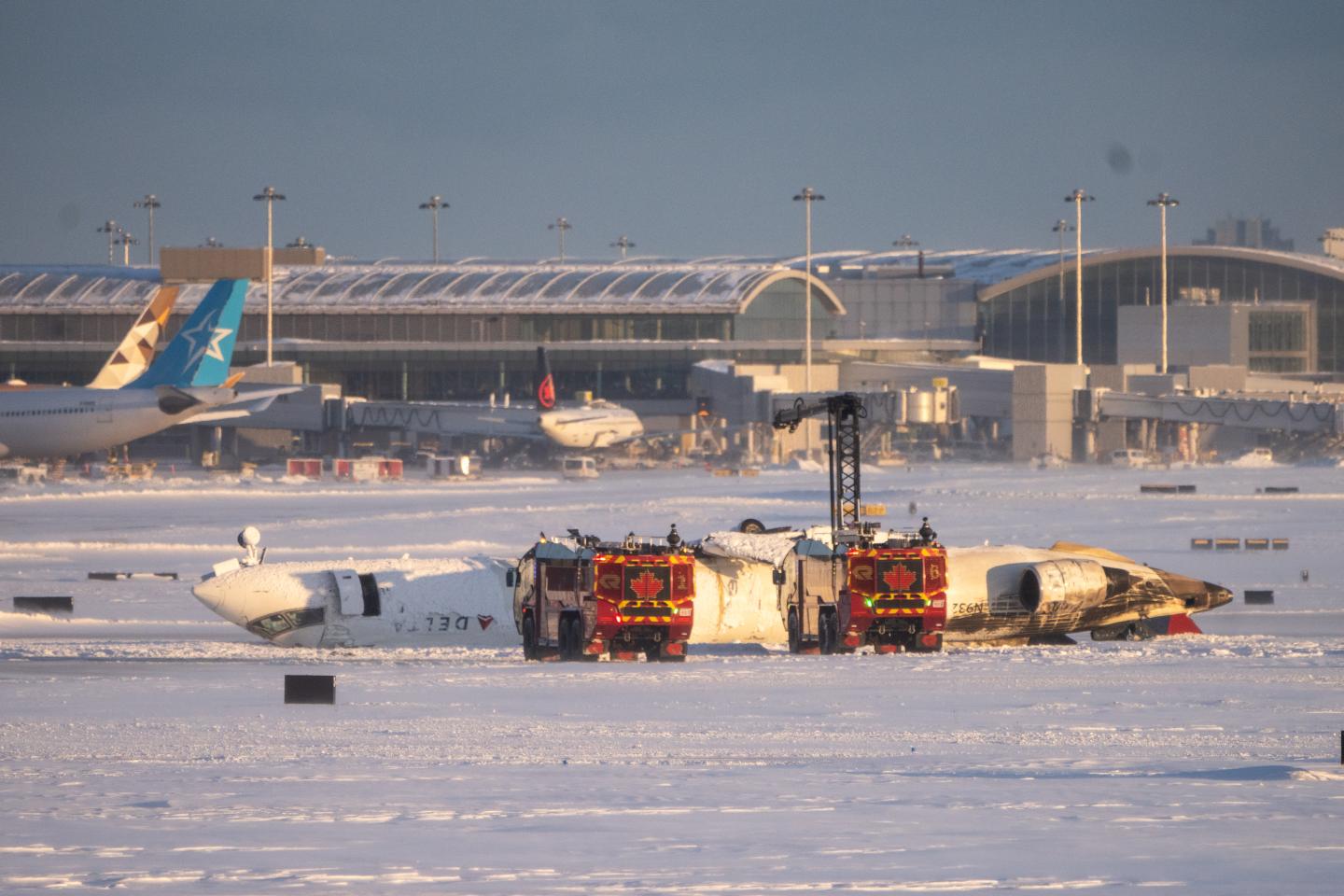 Photo: TORONTO, CANADA - FEBRUARY 17: Emergency personnel work at the scene of a Delta Airlines plane crash at Toronto Pearson International Airport on February 17, 2025 in Toronto, Canada. Several passengers were injured on the flight arriving from Minneapolis, resulting in the suspension of all flights at Canada's busiest airport. (Photo by Katherine KY Cheng/Getty Images)