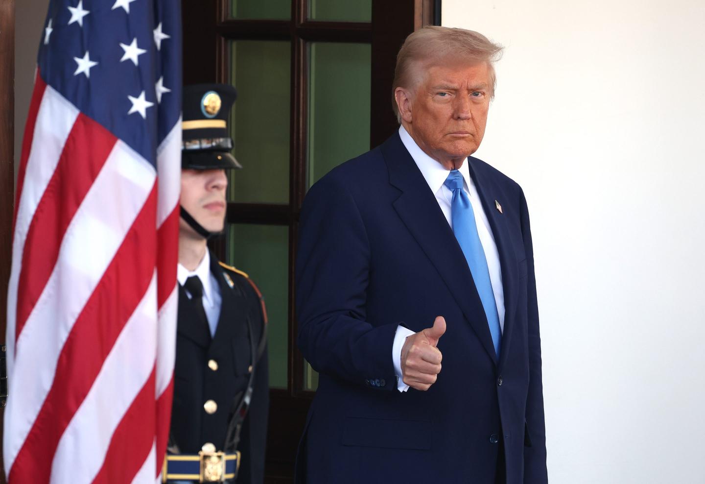 President Donald Trump waits outside the White House for French President Emmanuel Macron.
