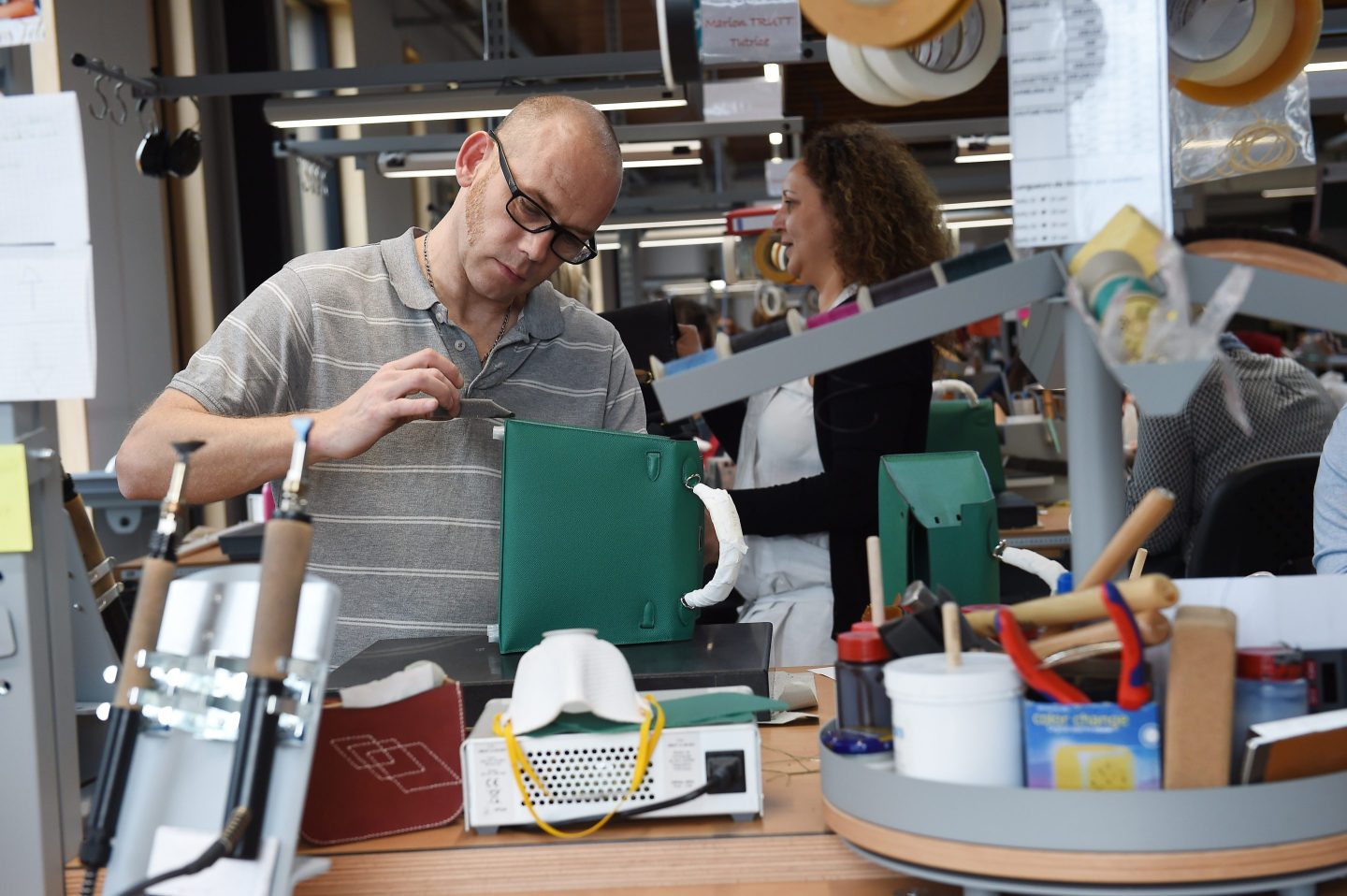 An employee works in the new leather goods workshop of French high fashion luxury goods manufacturer Hermes