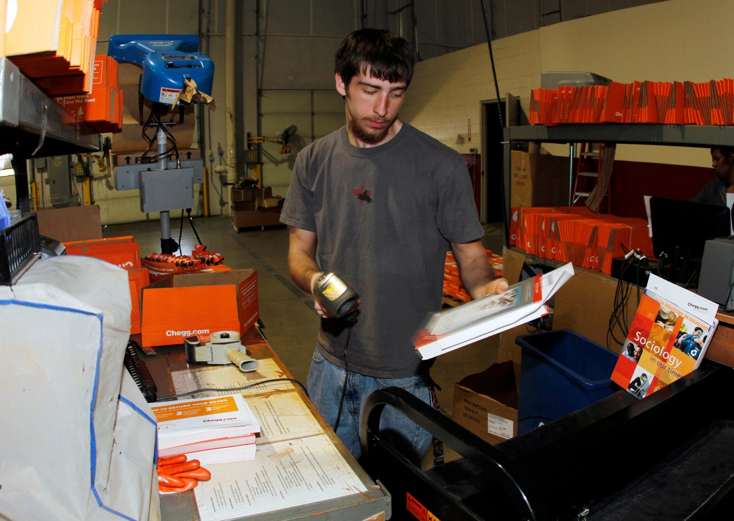 A Chegg worker prepares textbooks for shipping.