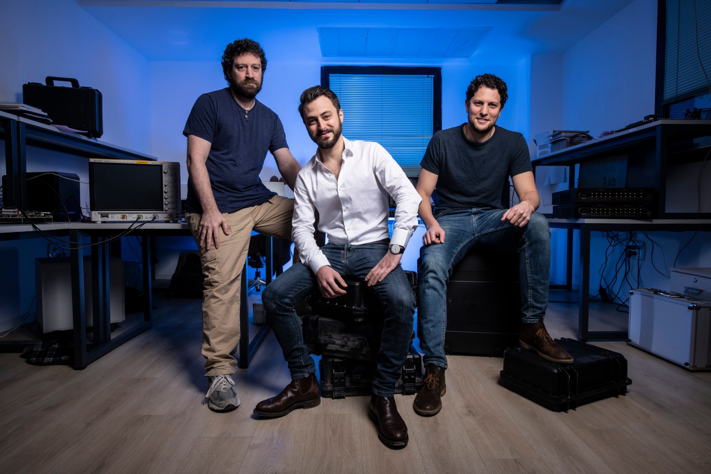 Picture of the QM founders, Dr Yonatan Cohen, Dr Itamar Sivan, Dr Nissim Ofek sitting in black cases.