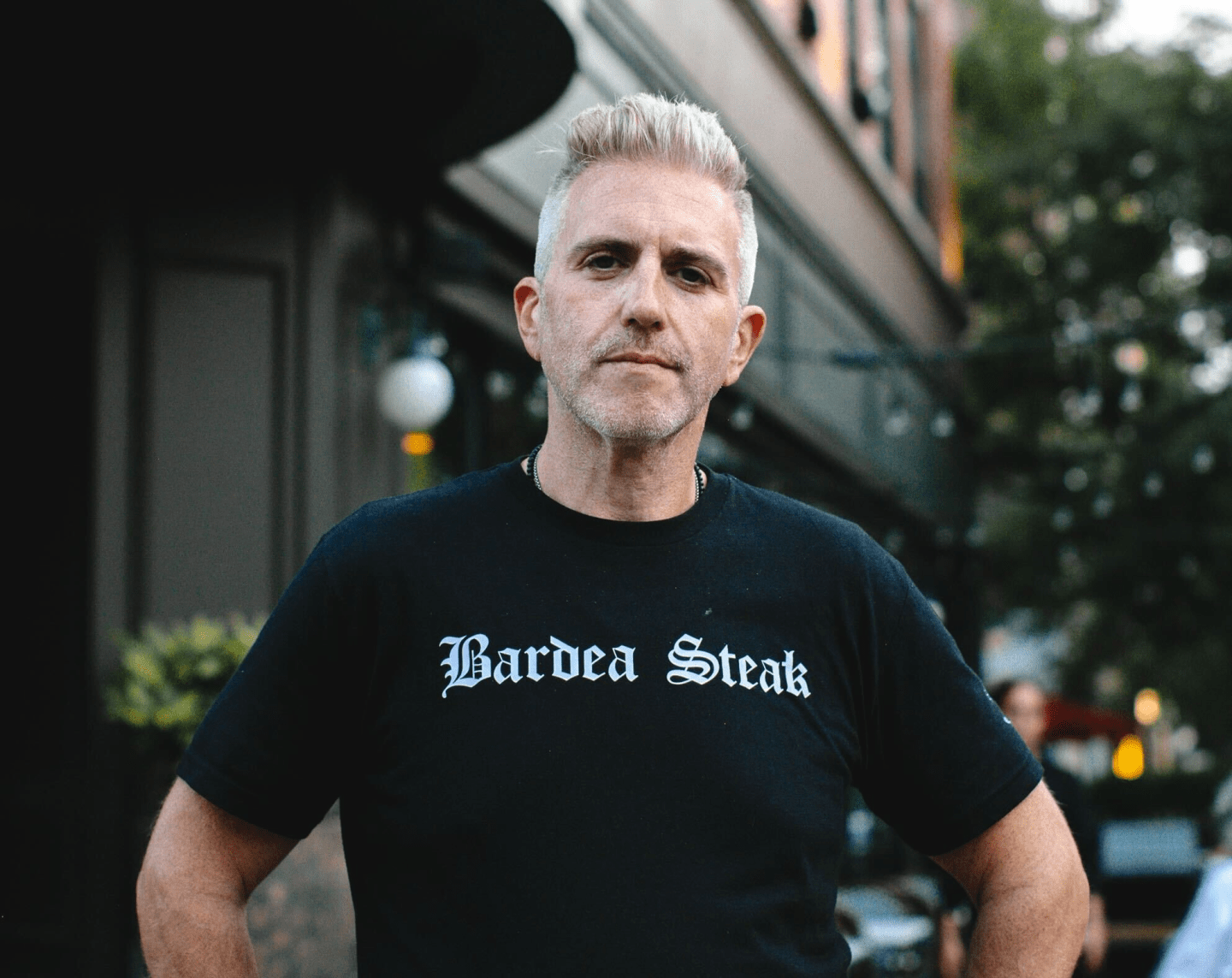 Scott Stein, wearing a black shirt with "Bardea Steak" spelled out in white letters, poses for a headshot.
