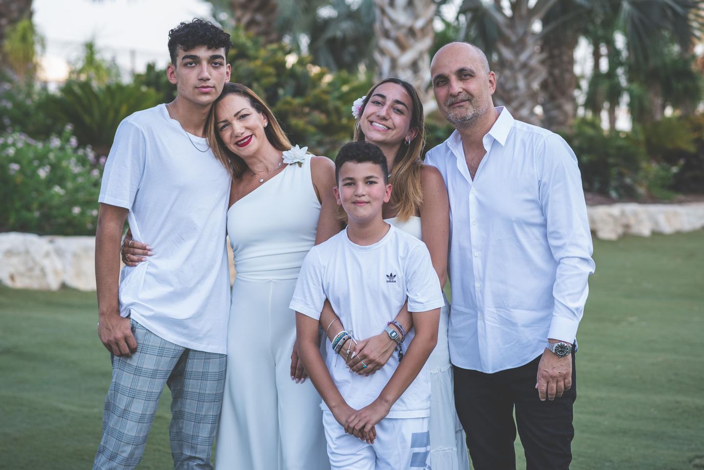 Edan Alexander, left, and his father Adi Alexander, right, and family.