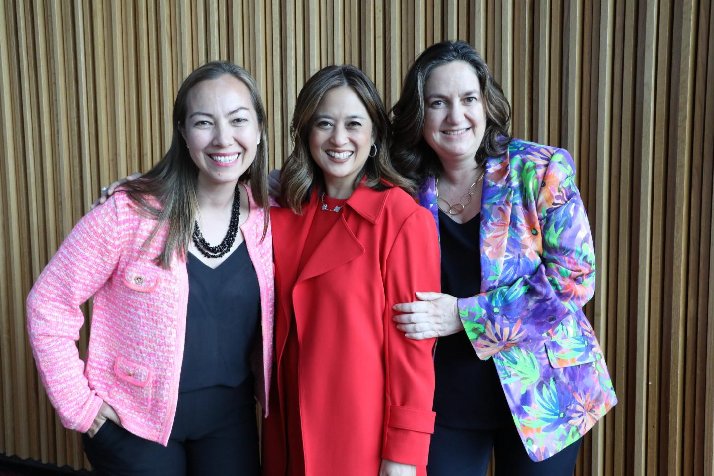 Three women pose for a photo
