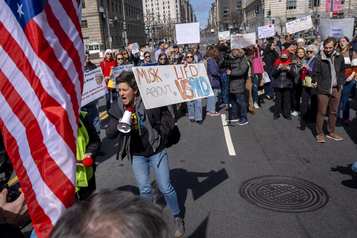 People rally on 14th St NW in support of fired USAID workers during a protest, on Feb. 28, 2025, by the USAID headquarters in Washington. 