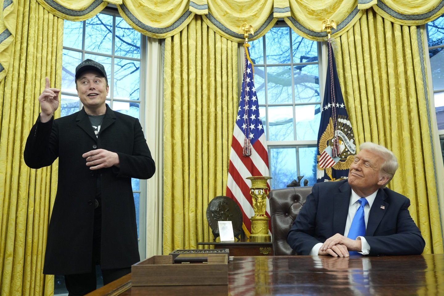 President Donald Trump listens as Elon Musk speaks in the Oval Office at the White House, on Feb. 11, 2025, in Washington.