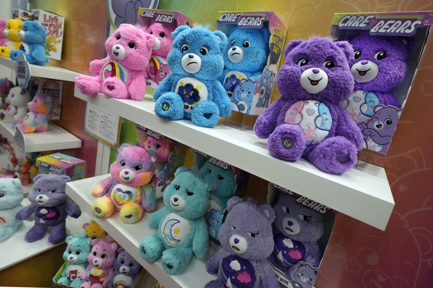 Care Bears sitting on a toy shelf
