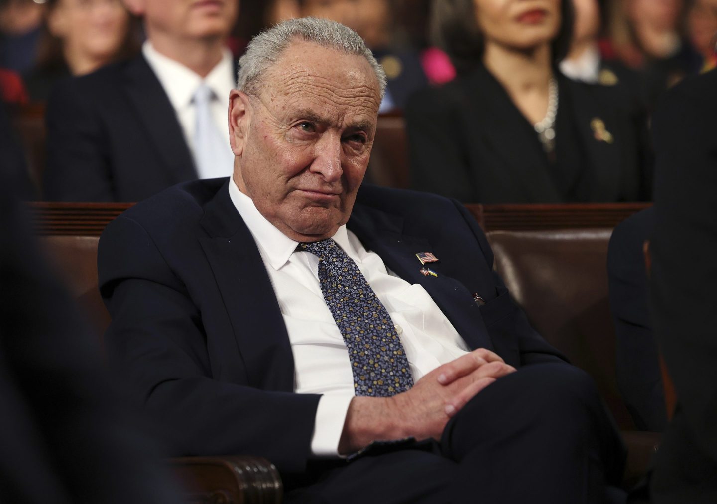 Senate Minority Leader Chuck Schumer listens as President Donald Trump addresses a joint session of Congress on March 4.