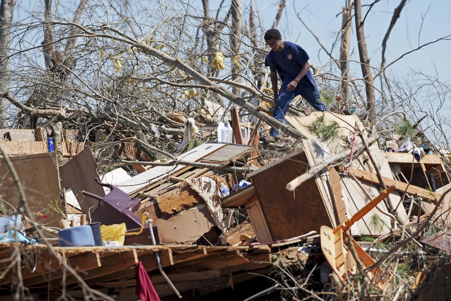 Mississippi couple huddle with huskies in Toyota while windows explode as storm that spawned tornadoes, dust storms and wildfires kills at least 39
