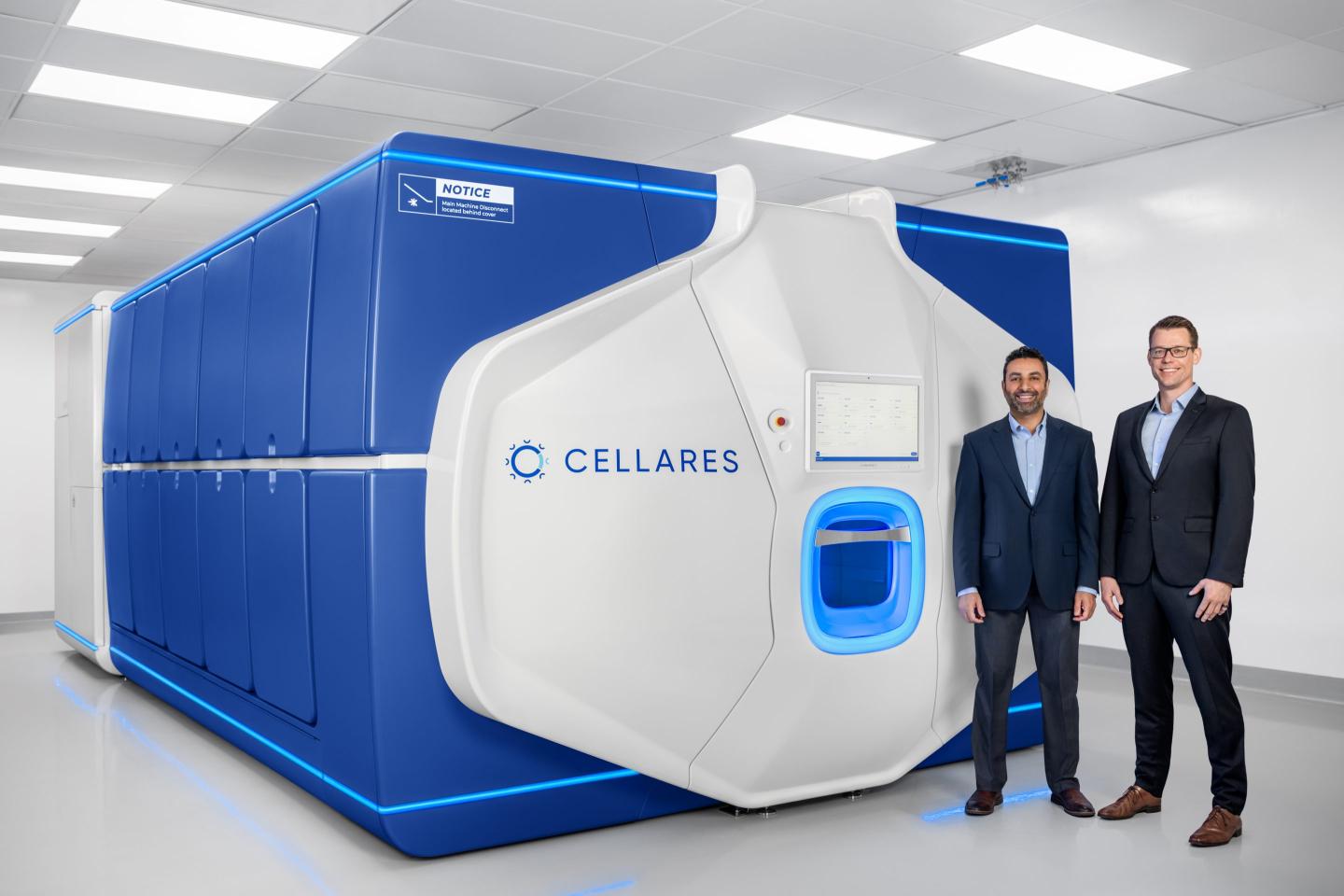 two men in suits pose in front of the cell shuttle