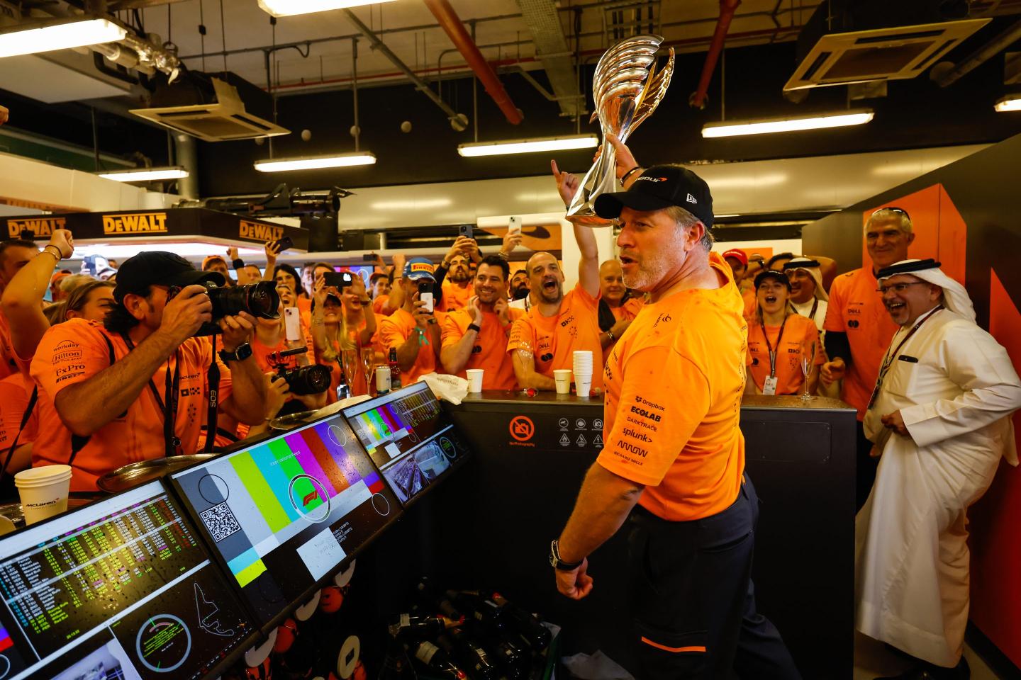 McLaren Racing CEO Zak Brown and team celebrate a win.