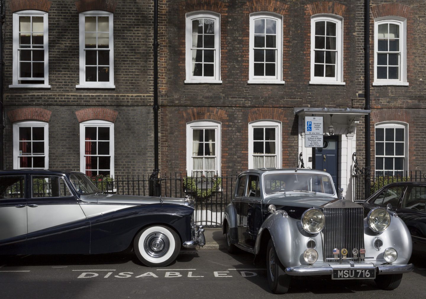 A 1964 Empress Bentley and a 1954 Rolls-Royce Silver Dawn are parked in Smith Square, a small square behind the Houses of Parliament, before collecting their VIP passengers - barristers who are being sworn in as QCs (aka Silks in legal vernacular), on 11th March 2019, in London, England.
