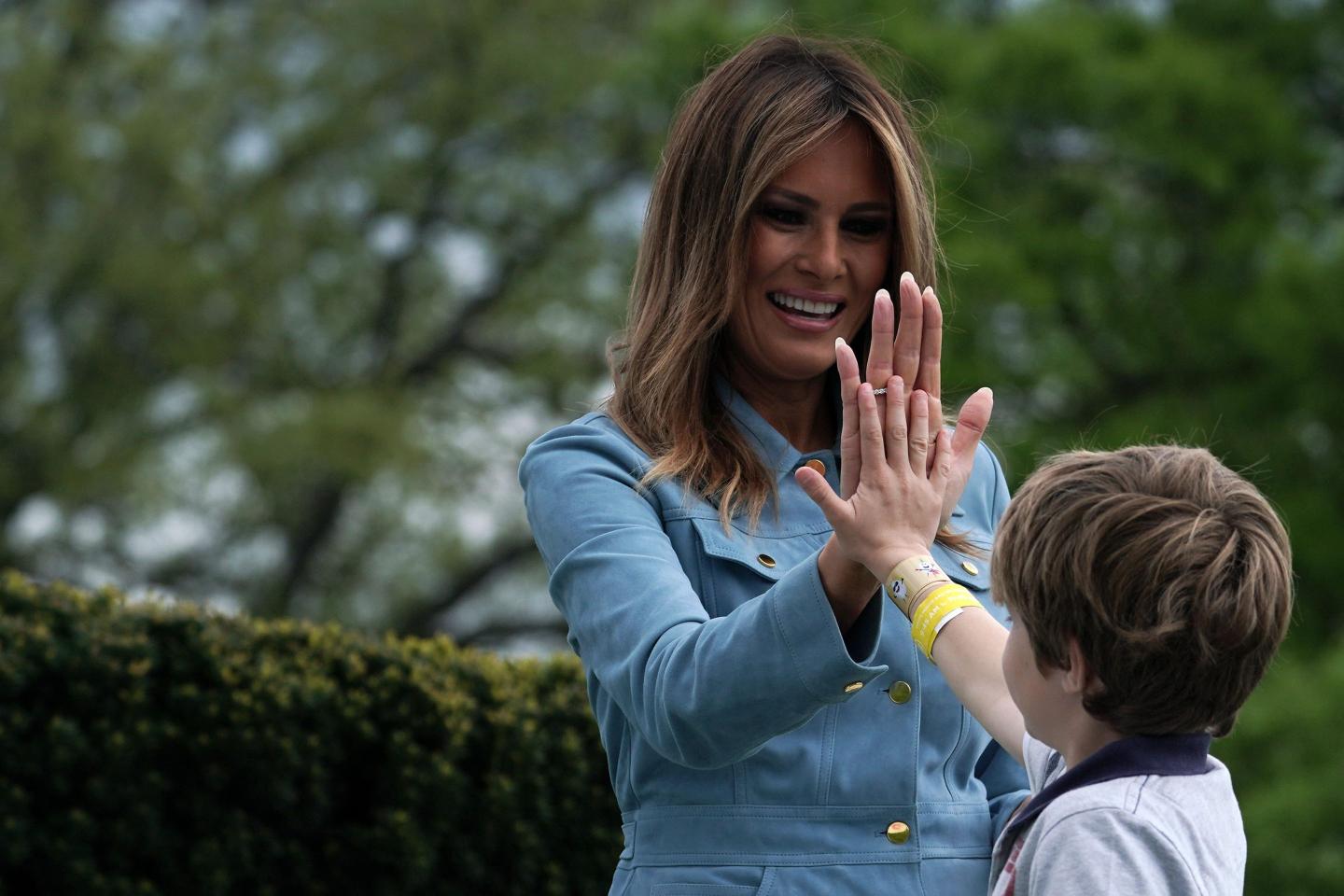 Melania Trump and a little boy high-five