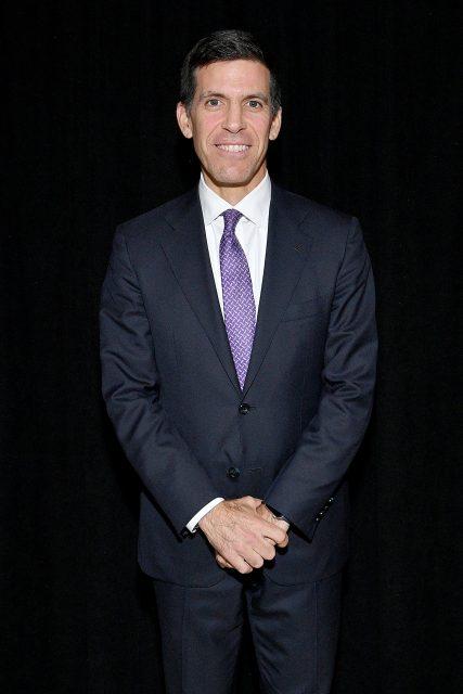 John Waldron of Goldman Sachs smiles for photographers