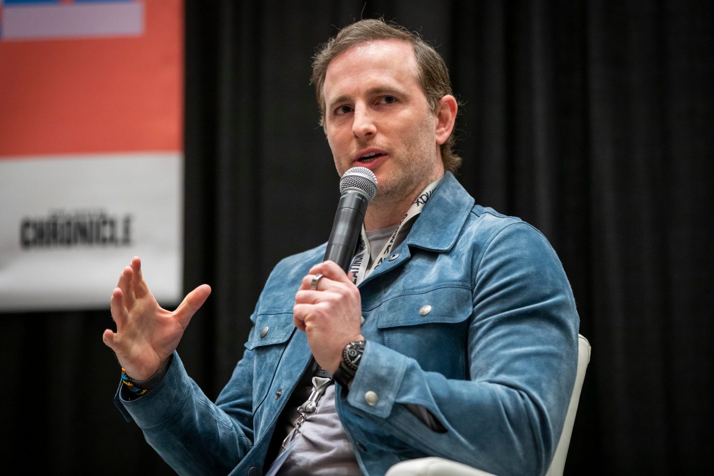 Joe Gebbia holds a microphone
