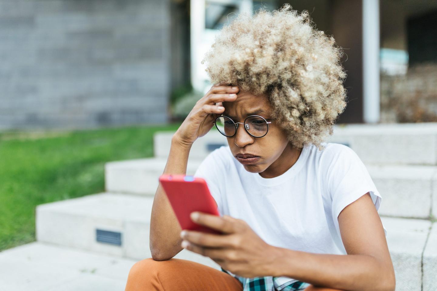 Young woman disappointed on her phone.