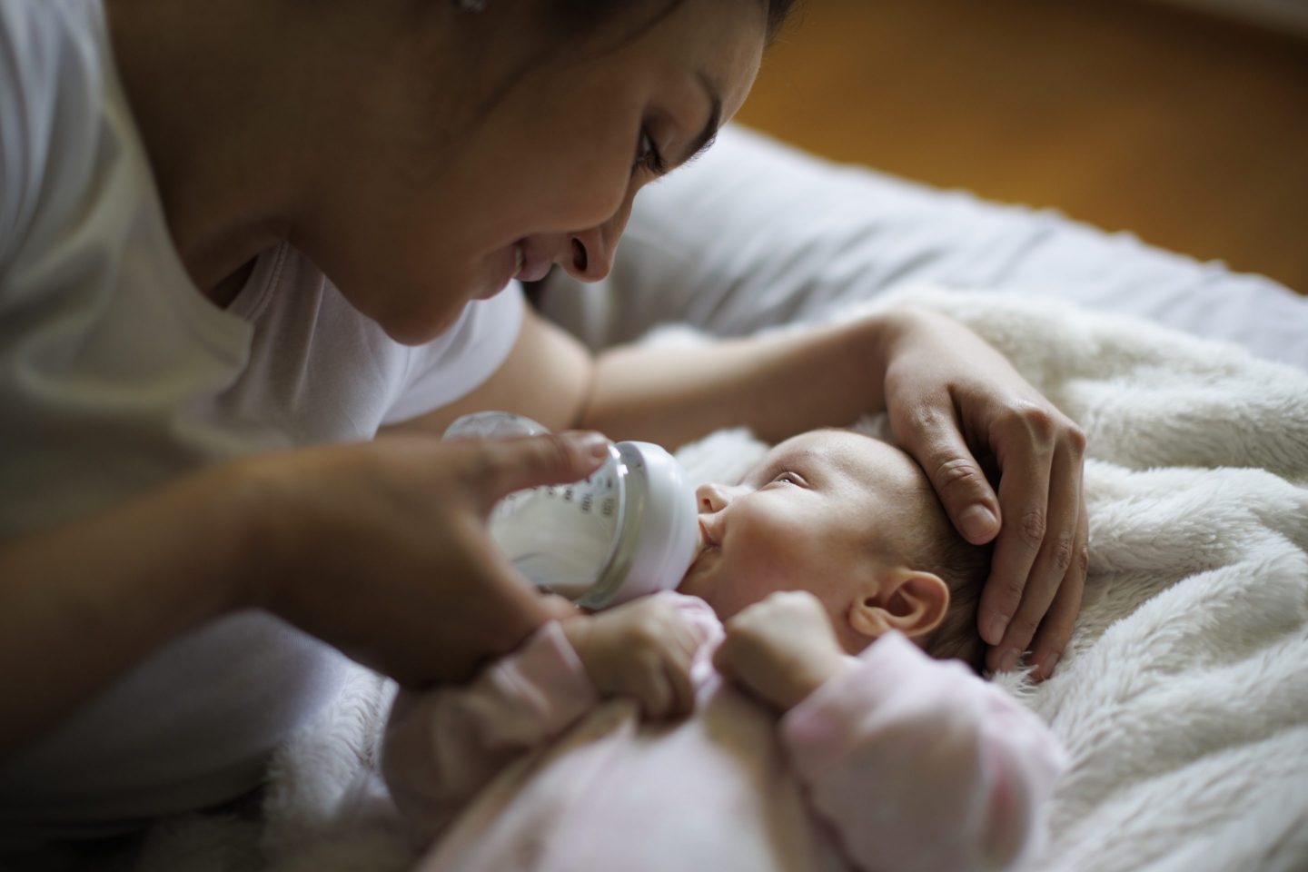 Mother feeding her baby with a bottle