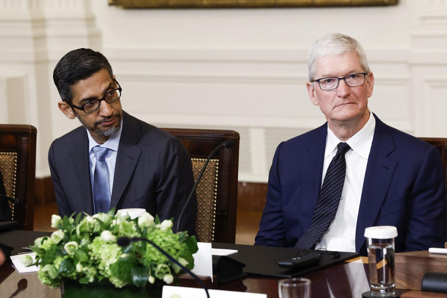Google CEO Sundar Pichai (L) and Apple CEO Tim Cook (R) listen as U.S. President Joe Biden speaks during a roundtable with American and Indian business leaders in the East Room of the White House on June 23, 2023 in Washington, DC.
