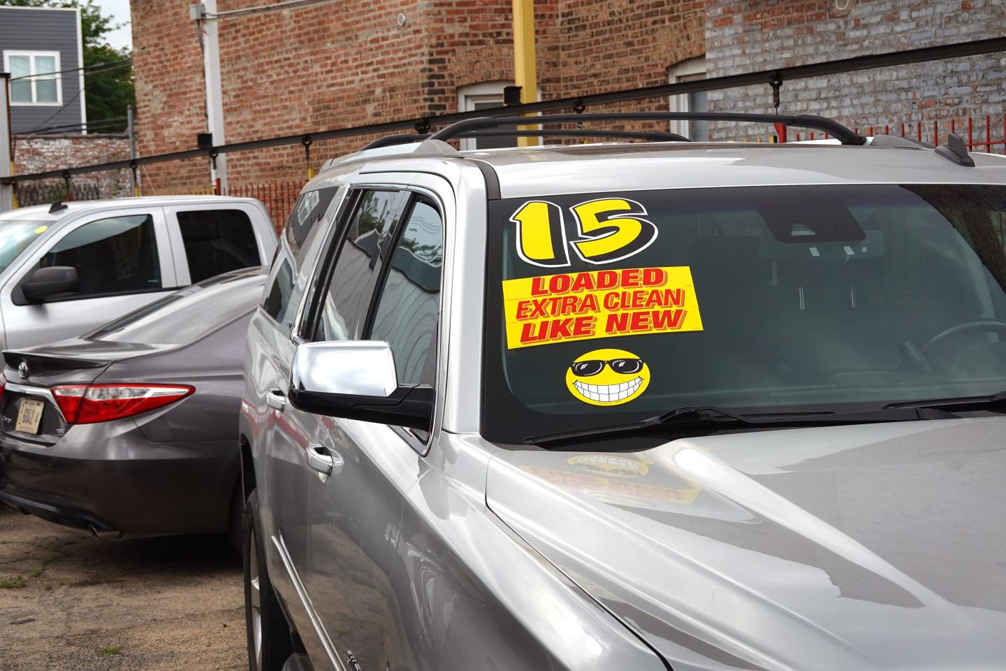 A sticker on a used car sitting in a lot