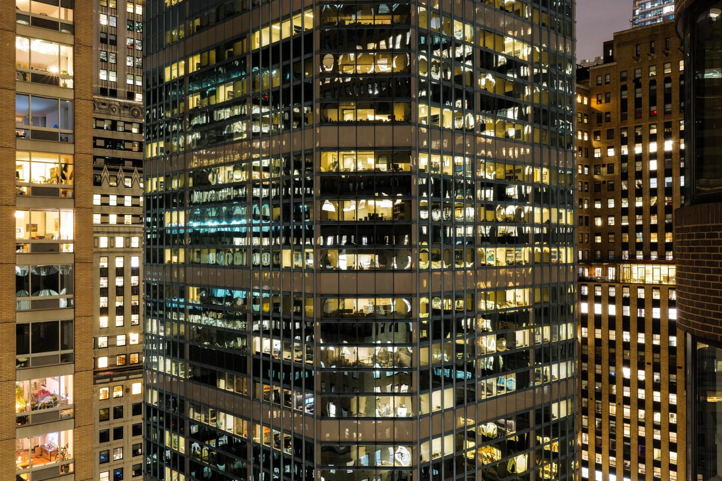 Residential and office buildings are pictured at night in the Manhattan borough of New York on January 29, 2024.