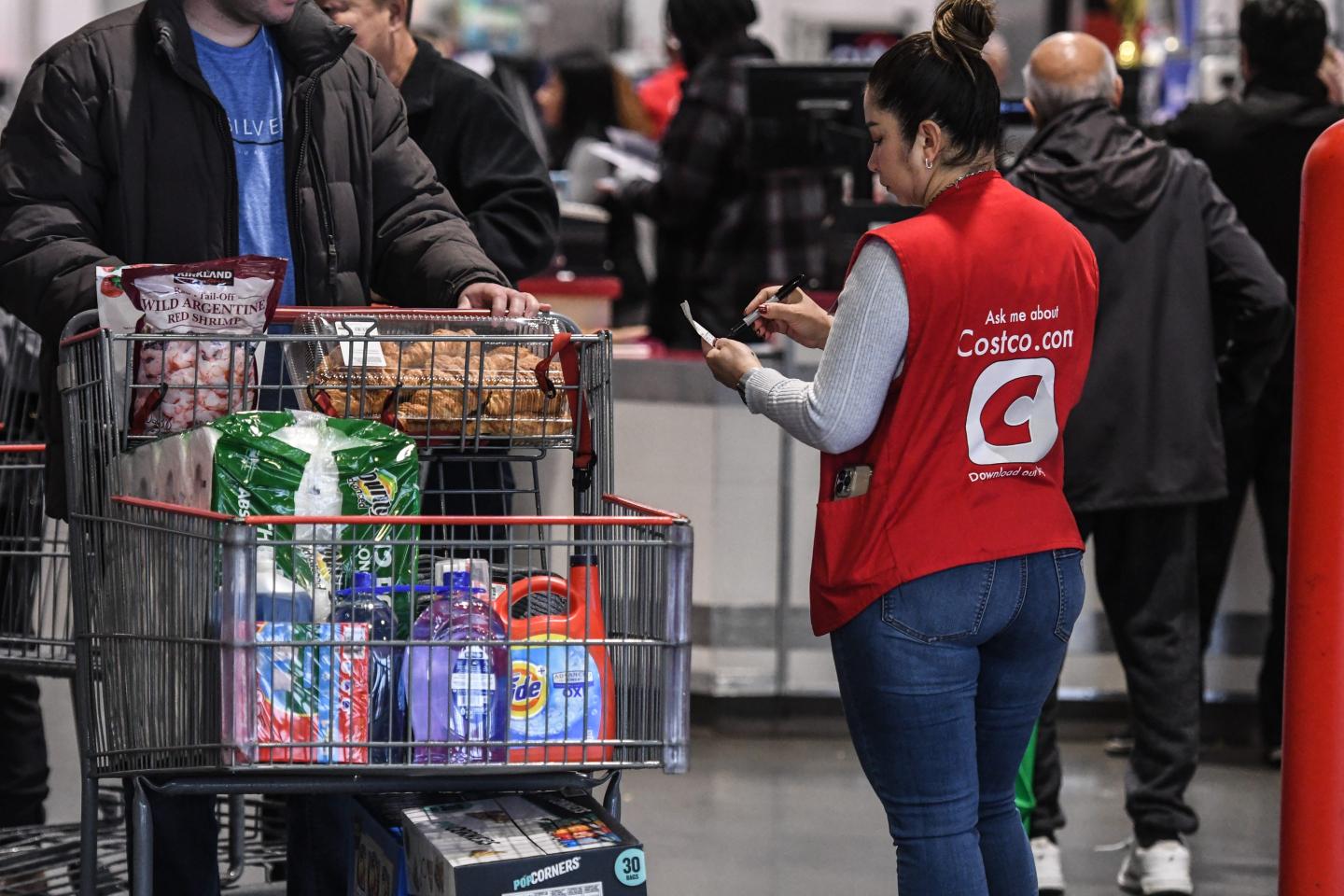 Coscto worker checking receipt