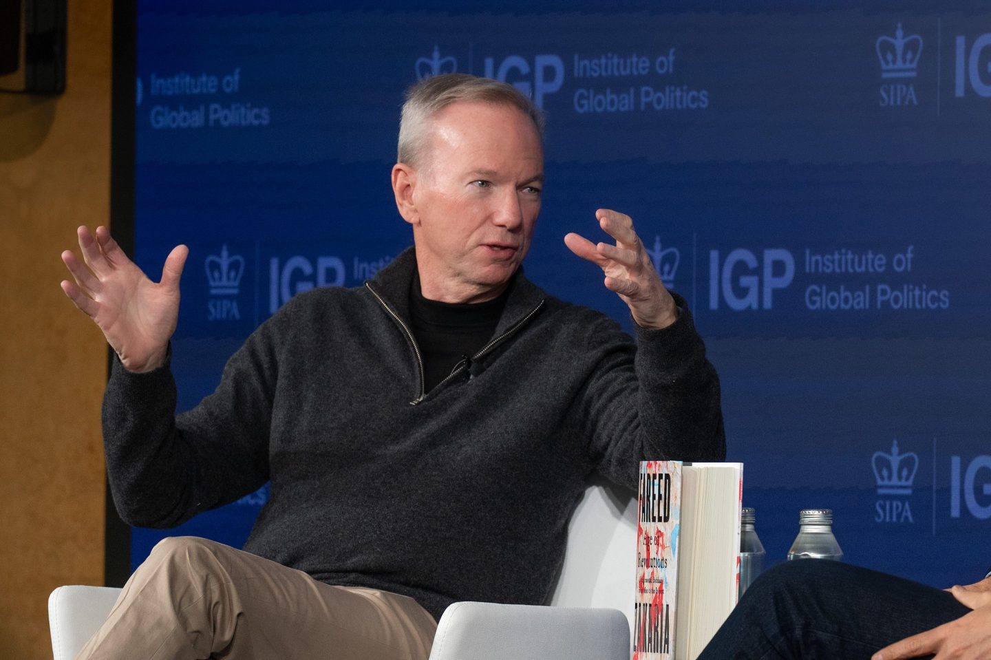 Eric Schmidt sat in a white chair, speaking on a stage.
