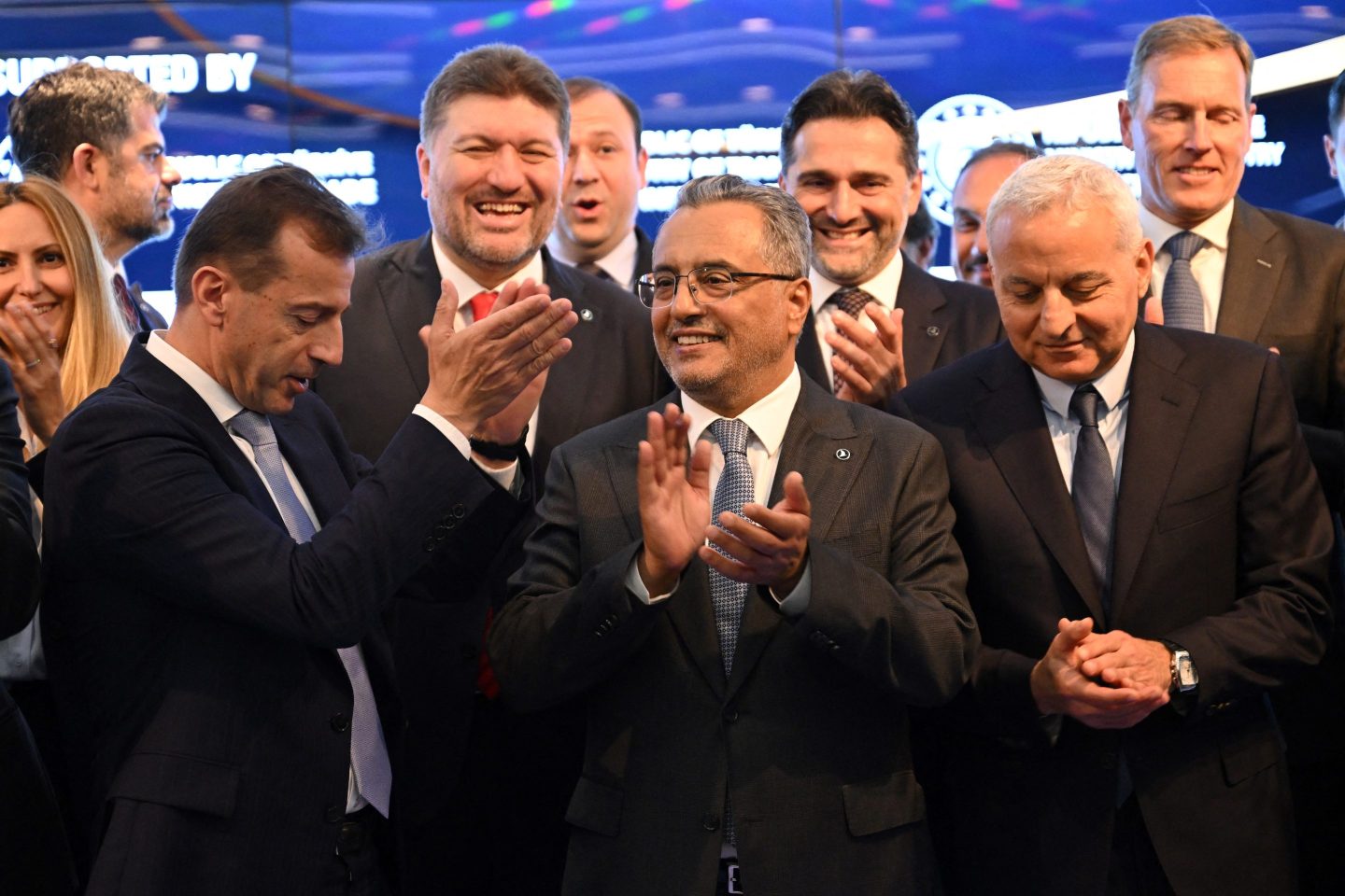 Airbus general director Guillaume Faury (front L), Turkish Airlines Chairman of the Board Ahmet Bolat (C) and Rolls Royce general director Tufan Erginbilgic (R) applaud during an agreement signing cerenomy on April 29, 2024 at Turkish Airlines headquarters in Istanbul.