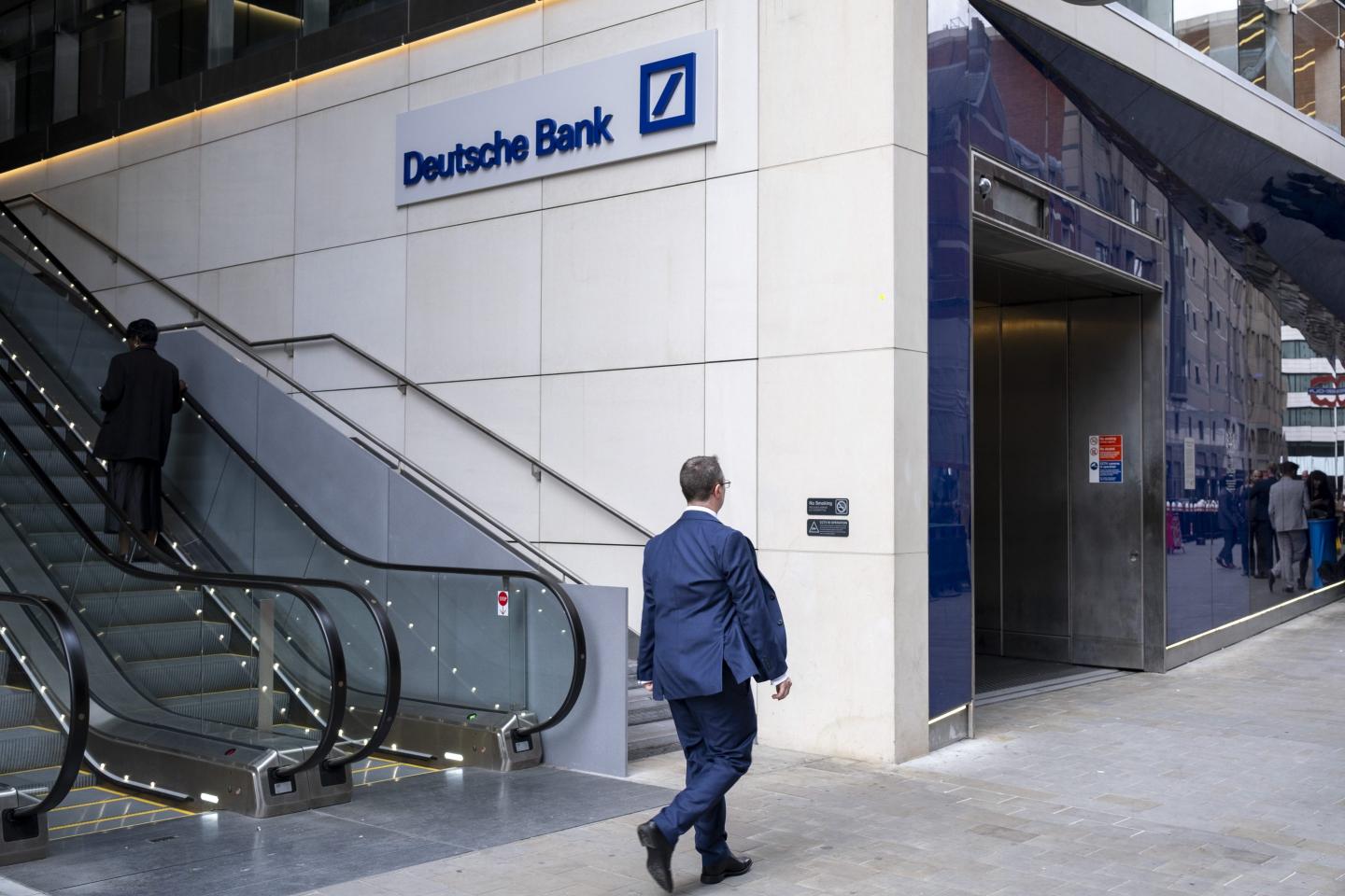 worker walking into Deutsche Bank