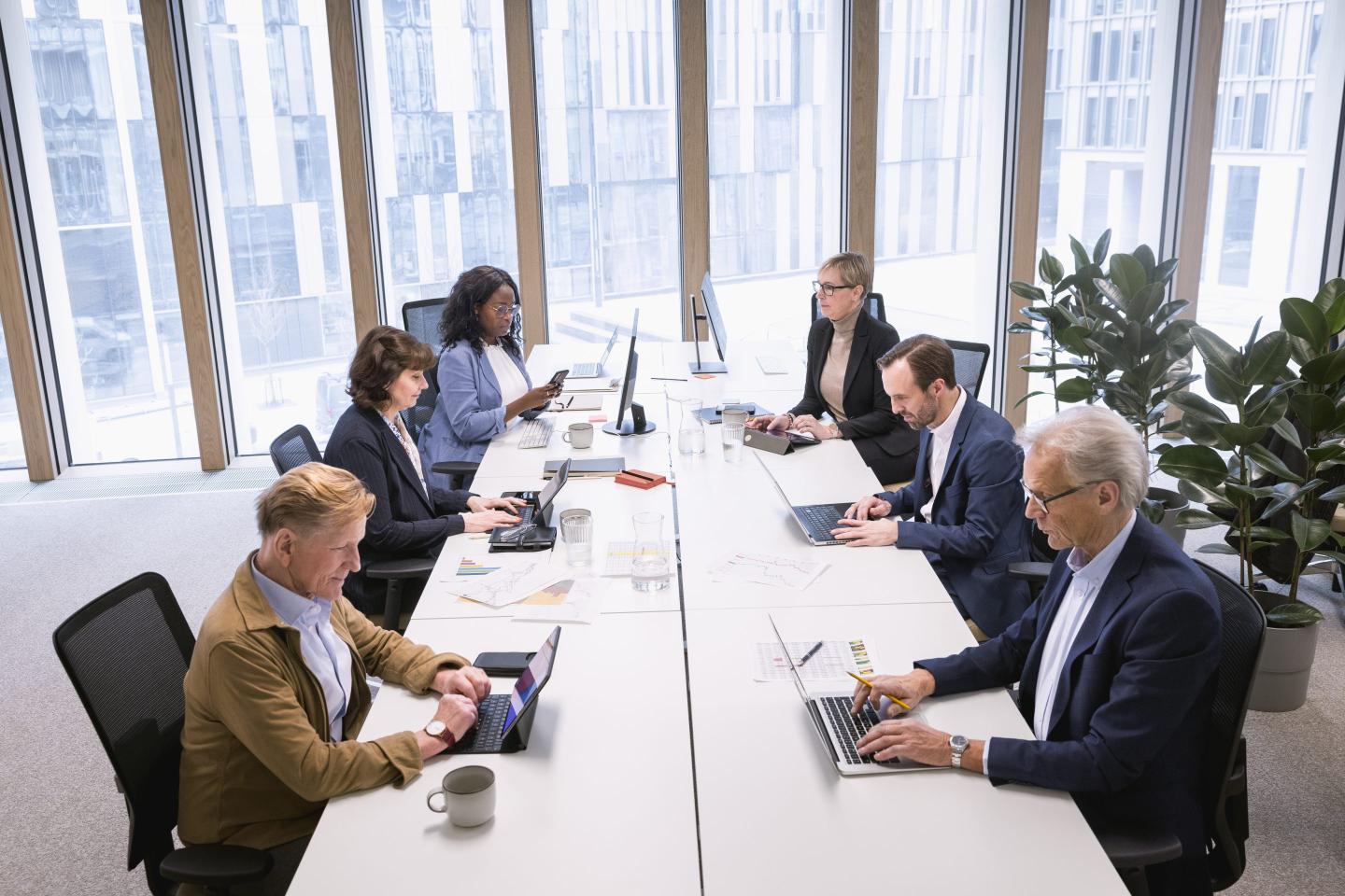 Multiracial corporate colleagues working in office