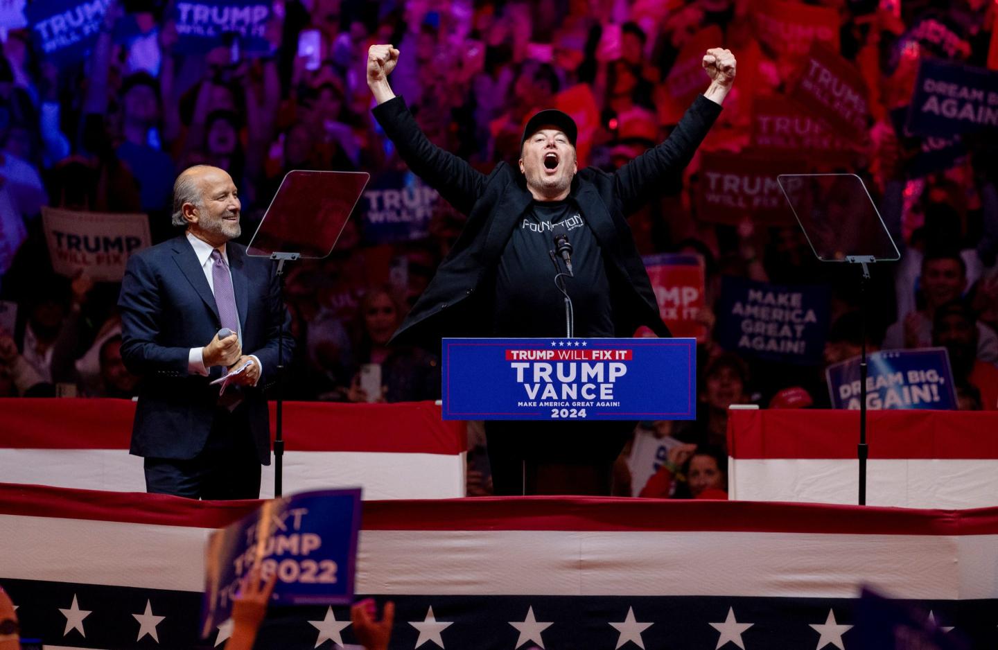 Howard Lutnick, chairman and chief executive officer of Cantor Fitzgerald LP, left, and Elon Musk, chief executive officer of Tesla Inc., during a campaign event for Donald Trump.