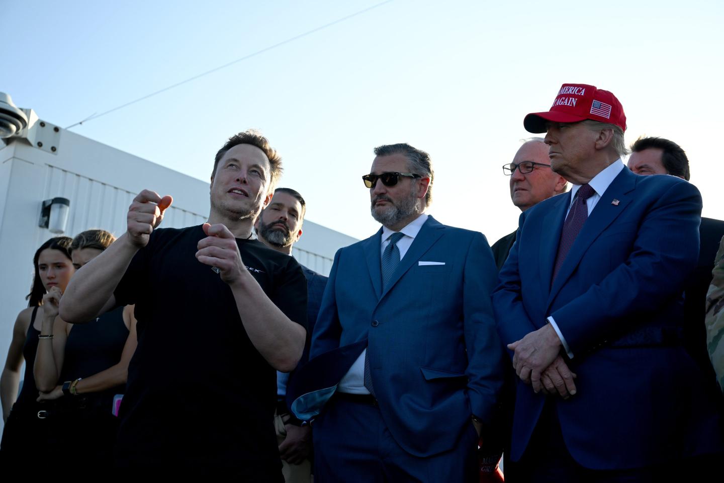 Elon Musk speaks with U.S. President-elect Donald Trump (R) and guests including Donald Trump Jr. (2nd from left), Sen. Ted Cruz (R-TX) (C) and Kevin Cramer (R-ND) at a viewing of the launch of the sixth test flight of the SpaceX Starship rocket on November 19, 2024 in Brownsville, Texas.