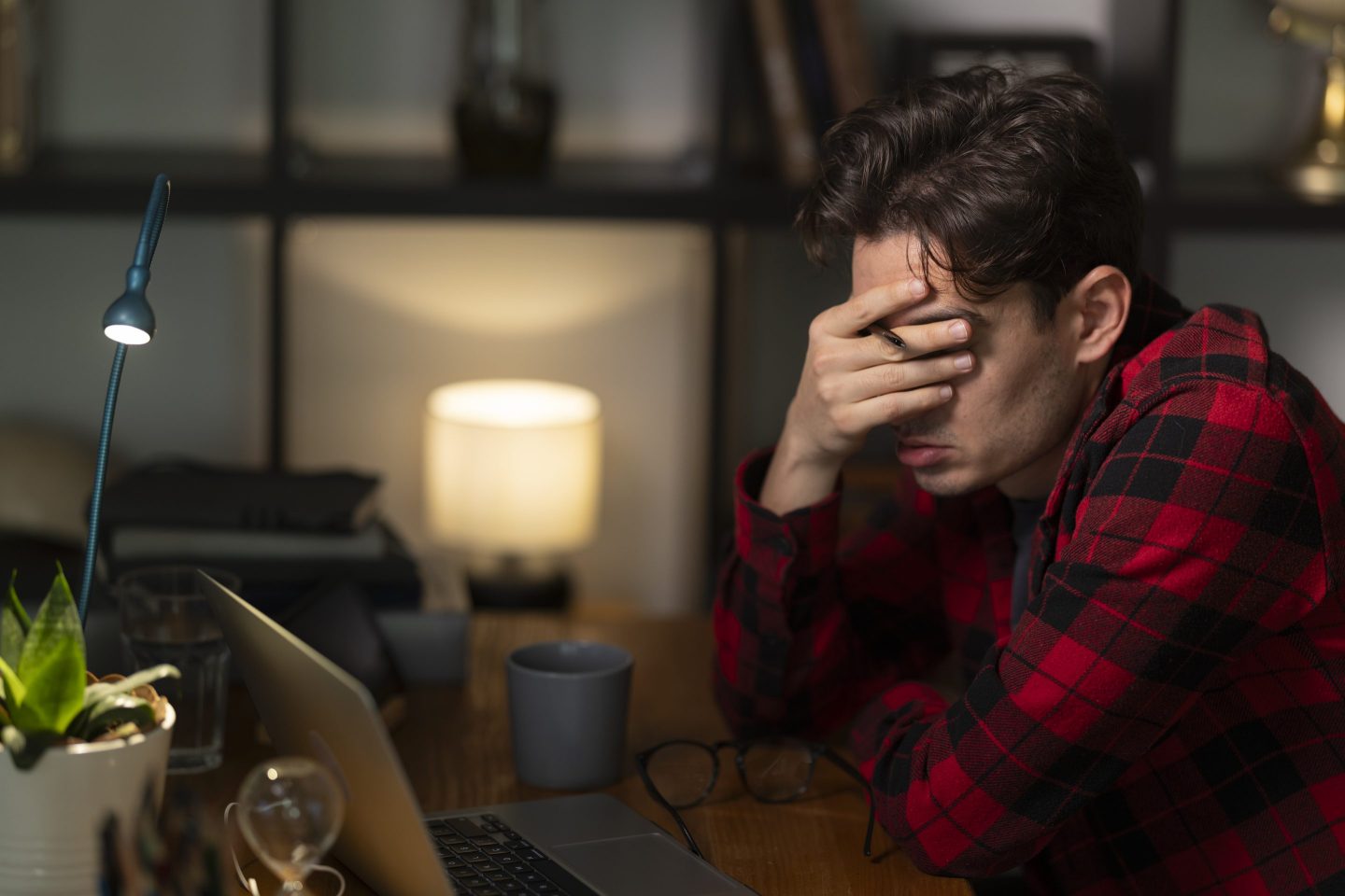 person looking stressed at a desk