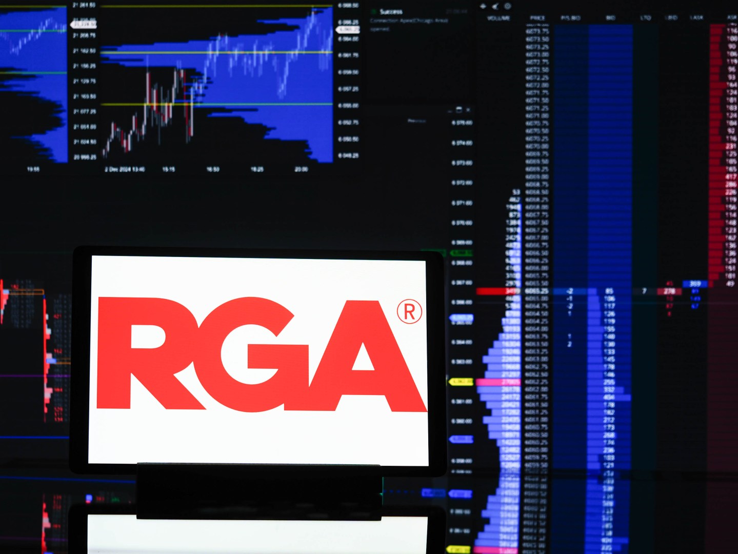 Reinsurance Group of America logo in front of stock monitors
