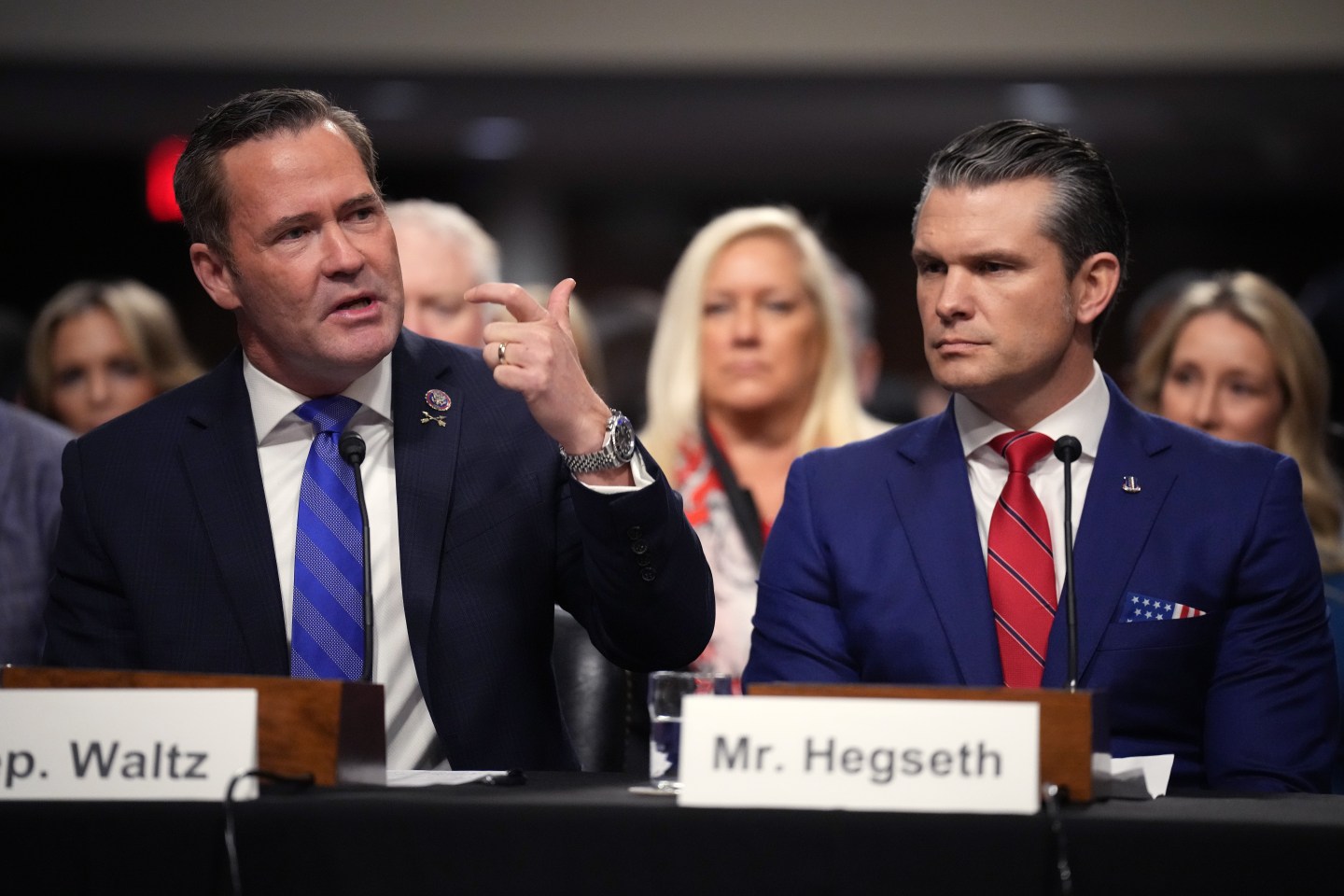 Michael Waltz and Pete Hegseth sitting next to one another.