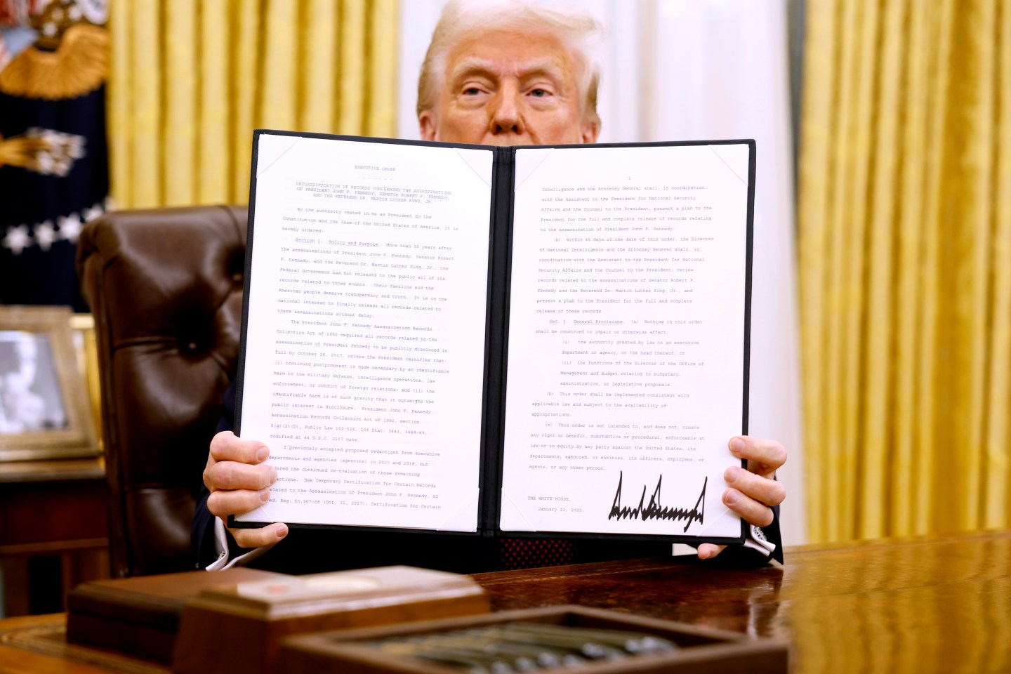 U.S. President Donald Trump holds up a signed executive order in the Oval Office of the White House on January 23, 2025 in Washington, D.C.(Photo: Anna Moneymaker/Getty Images)