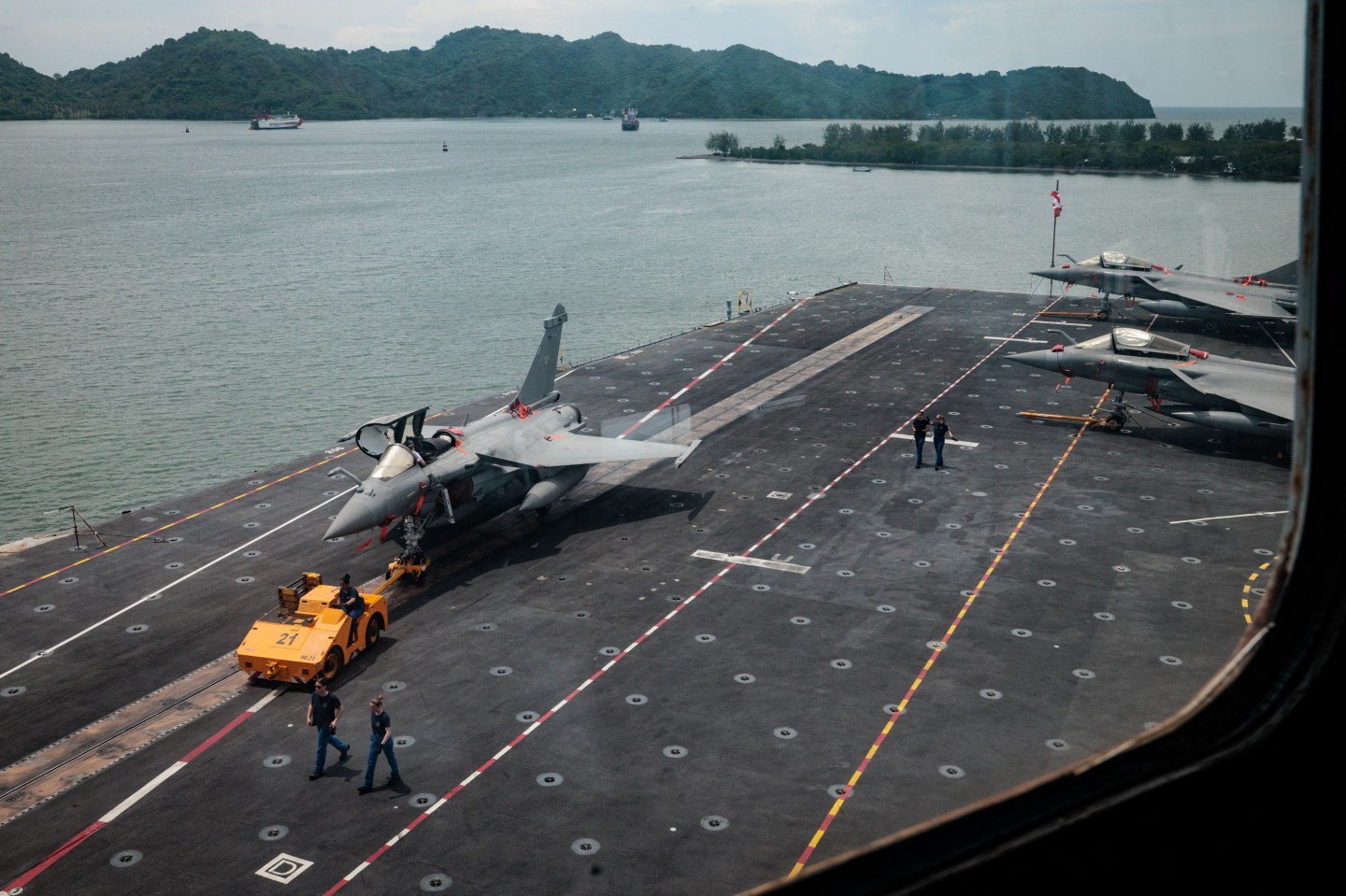 A Rafale jet fighter towed on the flight deck of the French Navy's nuclear-powered aircraft carrier called the Charles de Gaulle.