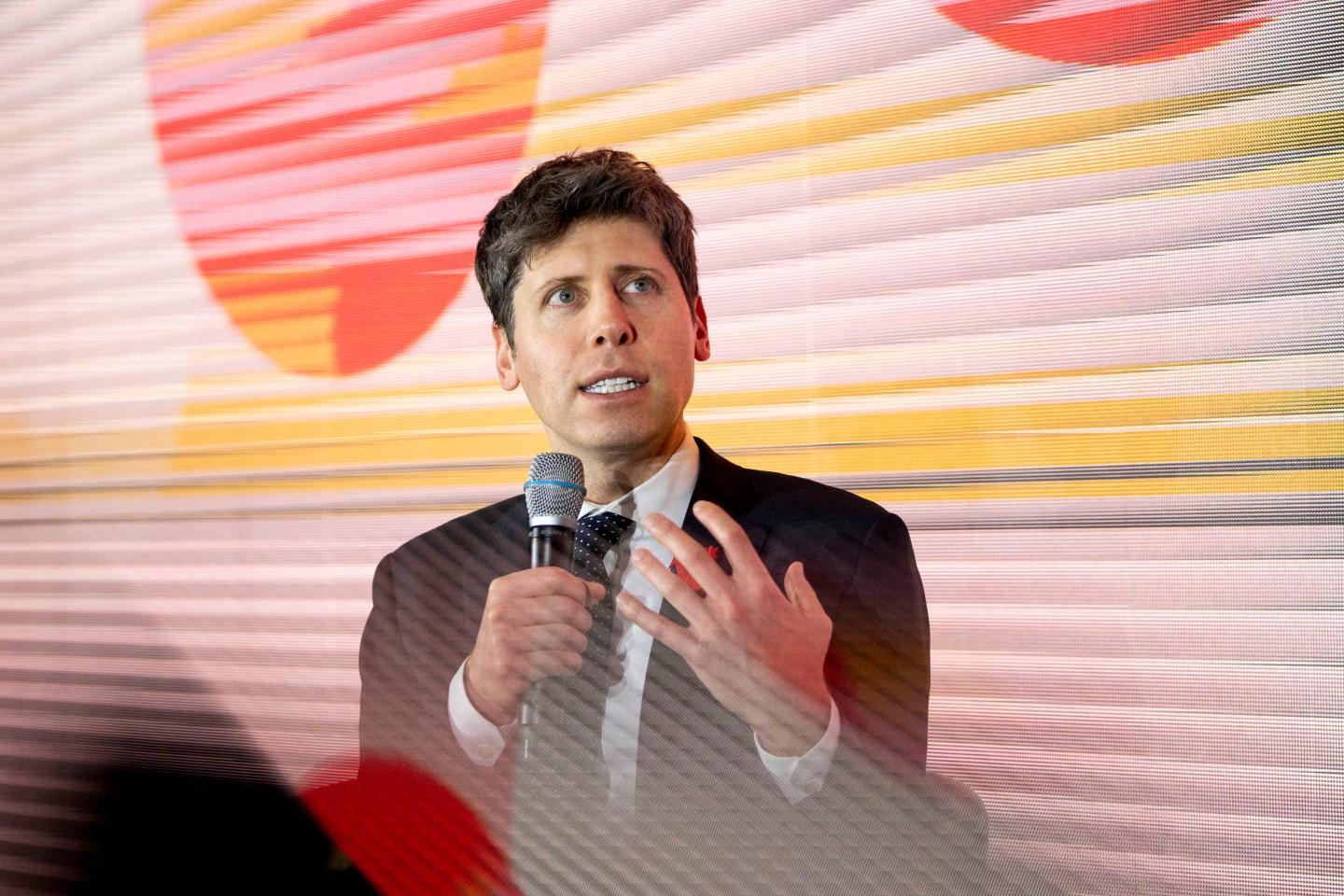 OpenAI CEO Sam Altman speaks into a microphone