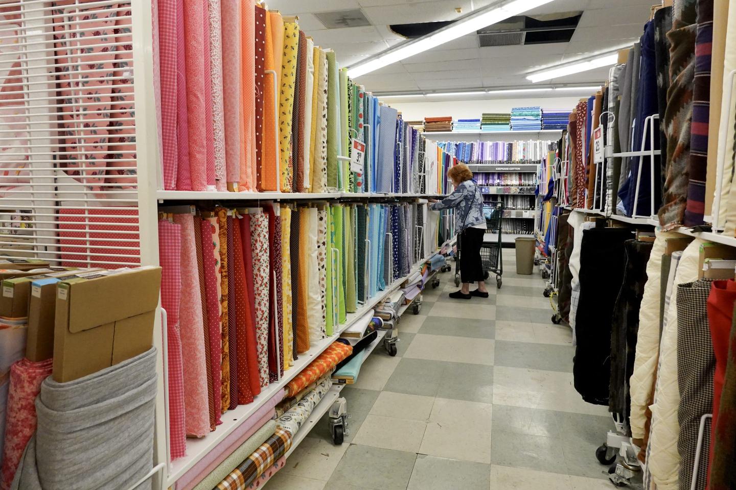An aisle with rows of colorful fabric at Joann Fabric.