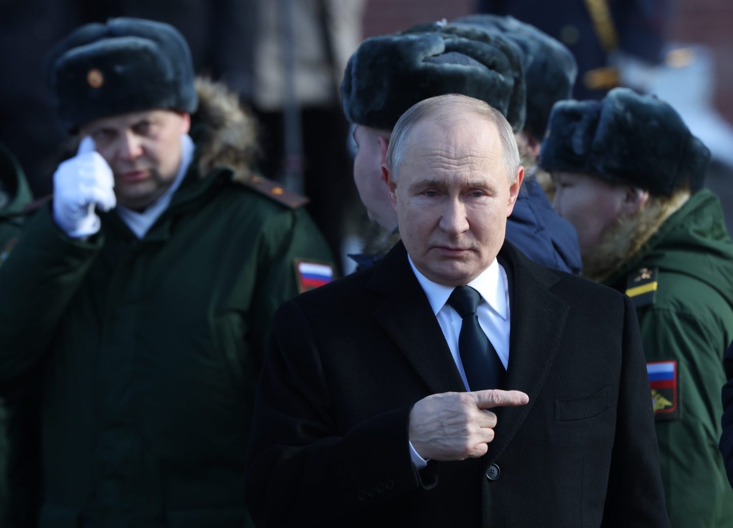 Russian President Vladimir Putin accompanied by military officers who have served in the invasion of Ukraine at a ceremony on Feb. 23.