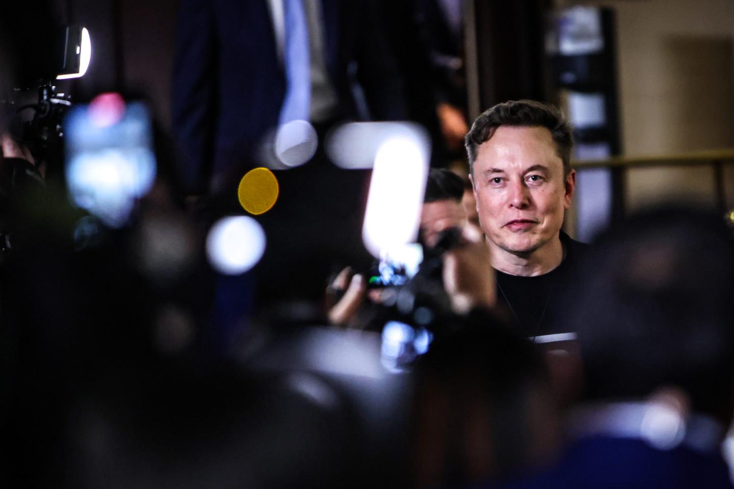 Elon Musk surrounded by abstract shapes
