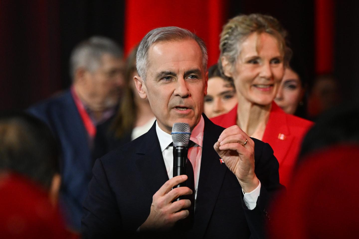 Canada's Prime Minister Mark Carney speaks into a microphone