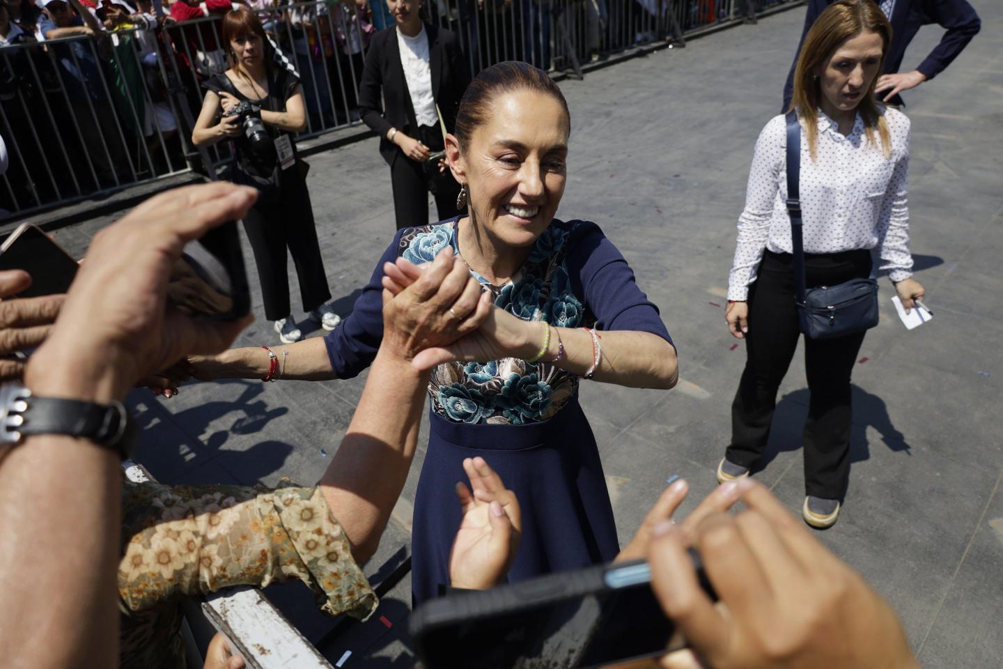 Claudia Sheinbaum, president of Mexico, greets her followers during a message she gives at the Zocalo in Mexico City