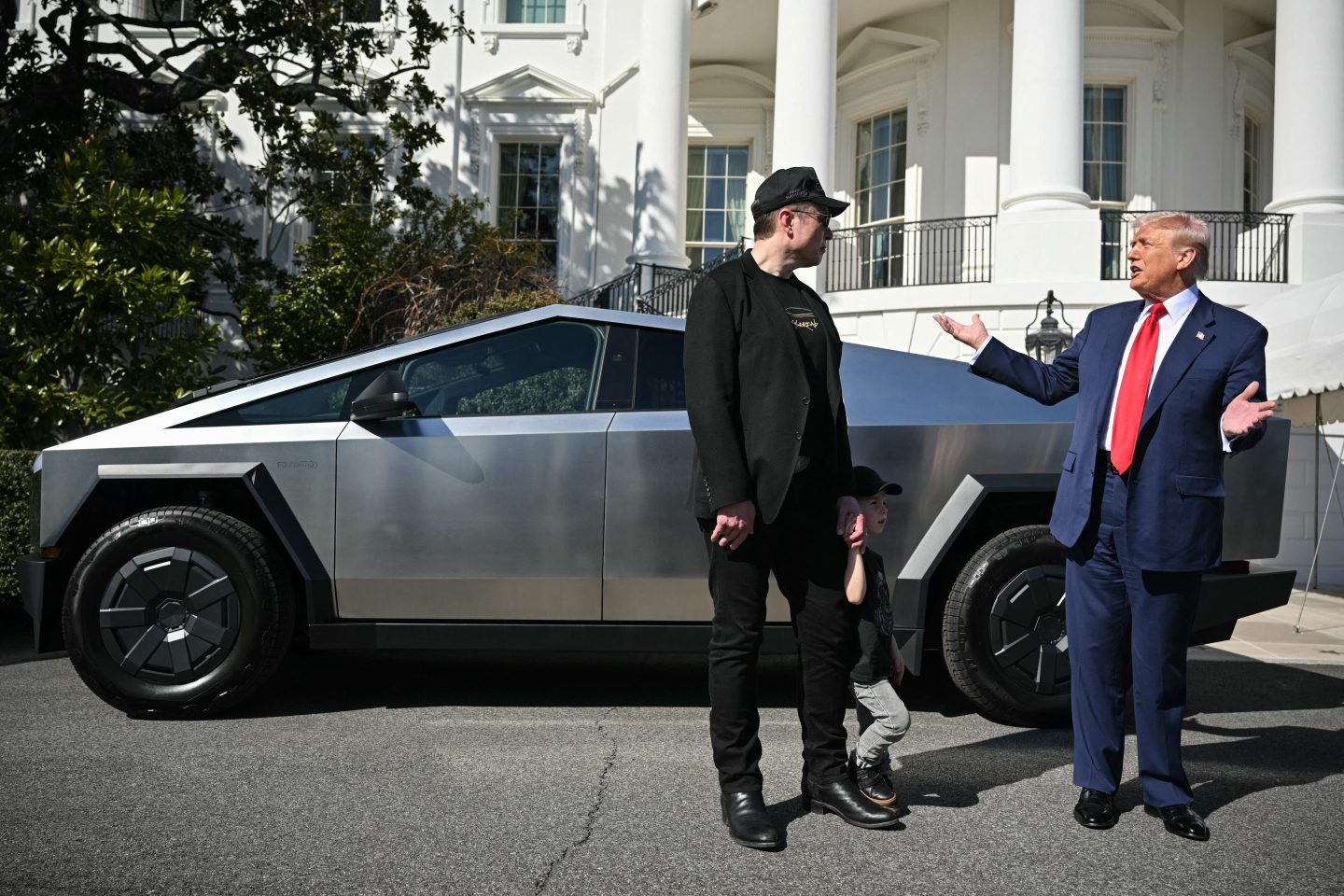 U.S. President Donald Trump and Tesla CEO Elon Musk stand next to a Tesla Cybertruck on the South Portico of the White House on March 11, 2025 in Washington, D.C. (Photo by Mandel Ngan/AFP/Getty Images)