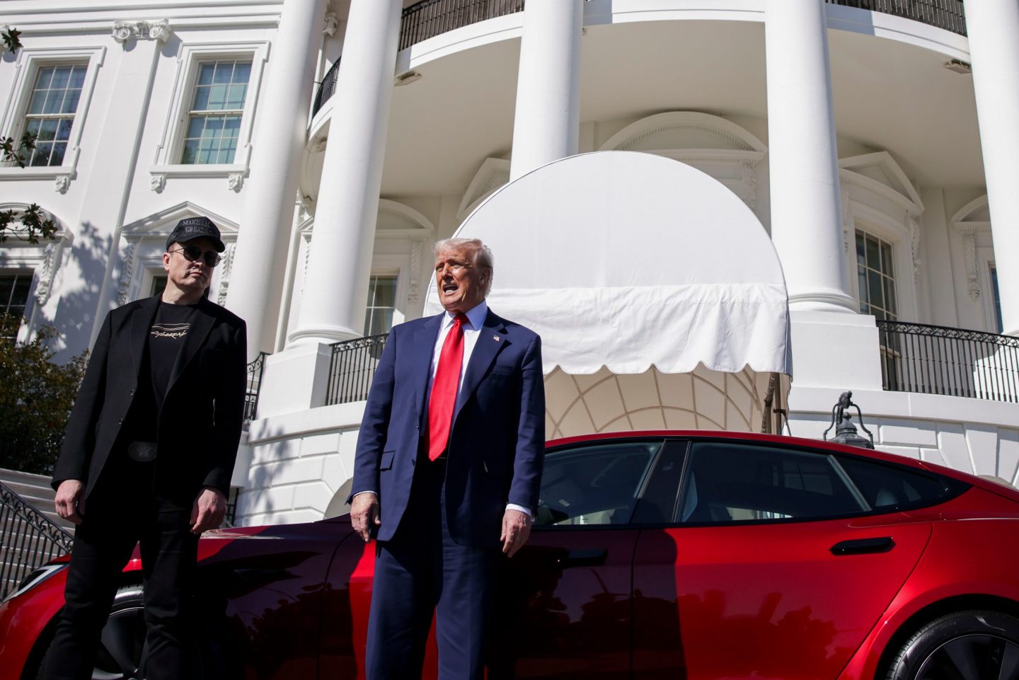 Elon Musk, Donald Trump, and a Tesla Model S at the White House.