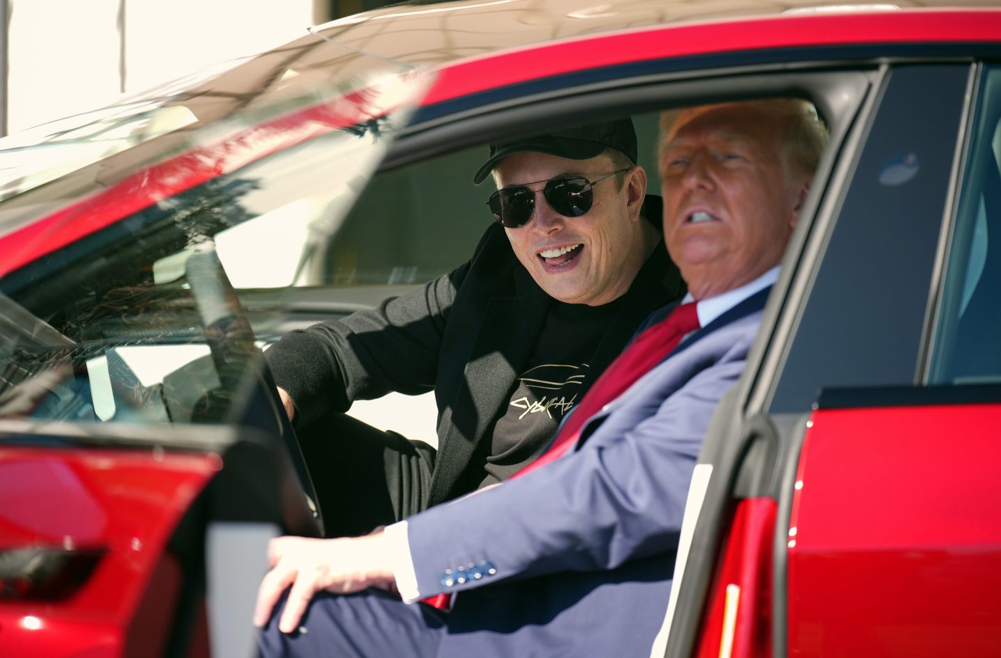 U.S. President Donald Trump and Tesla CEO Elon Musk sit in a Model S on the South Lawn of the White House.
