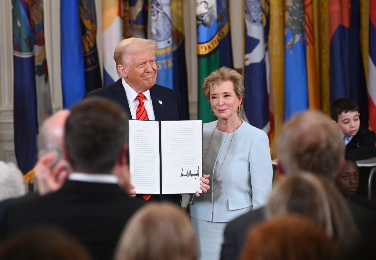 President Donald Trump and poses with U.S. Education Secretary Linda McMahon after he signed an executive order to formally begin the process of dismantling the Education Department.